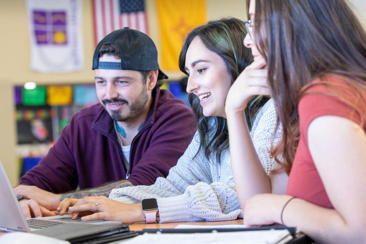 Students working together in front of computer